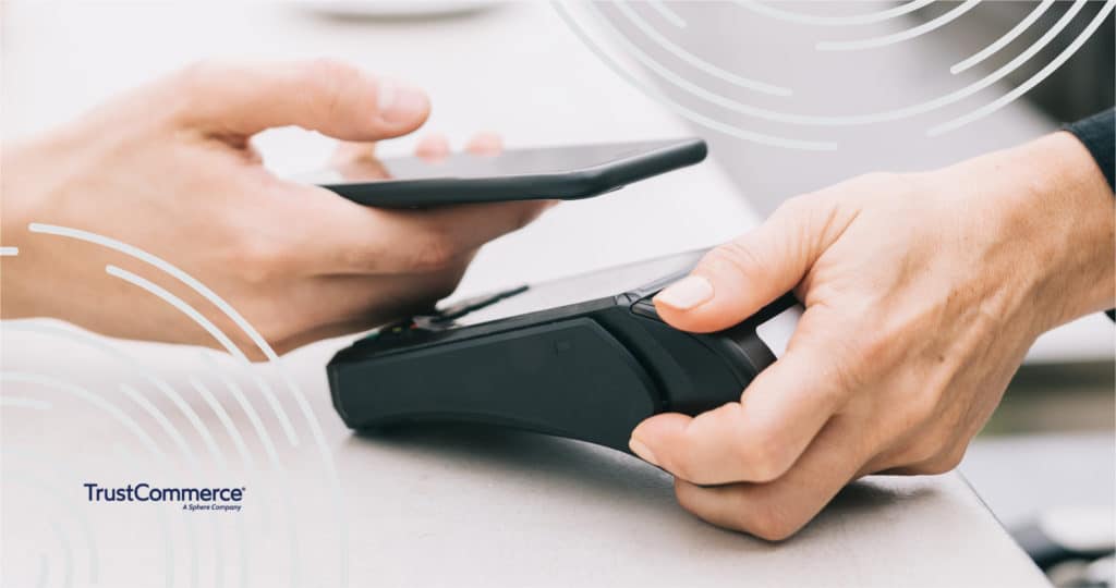 Close up of a hand using a phone to pay for healthcare services