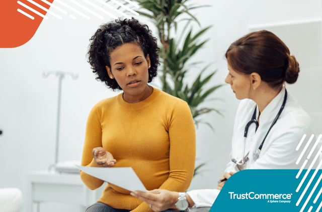 A female patient and doctor sitting next to each other reviewing paperwork