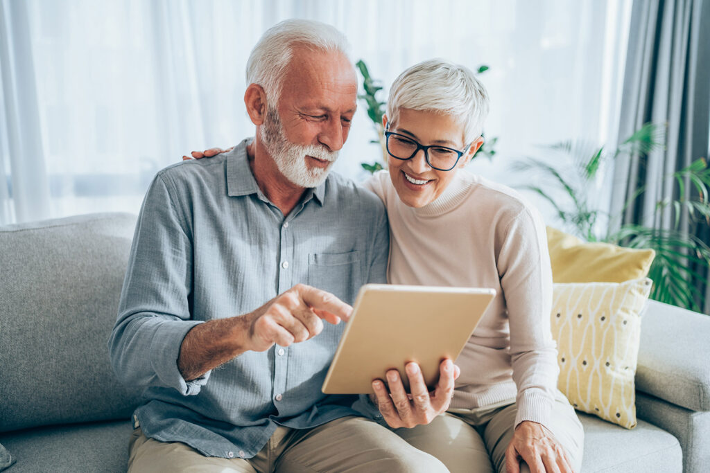 an image of an older couple looking at a tablet