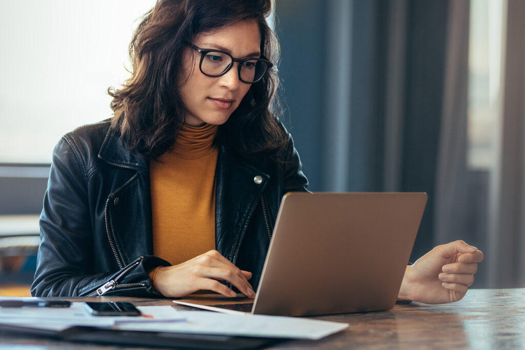 an image of a woman working on a laptop