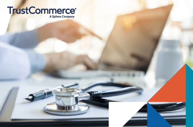 Healthcare worker using a computer with a stethoscope by their side